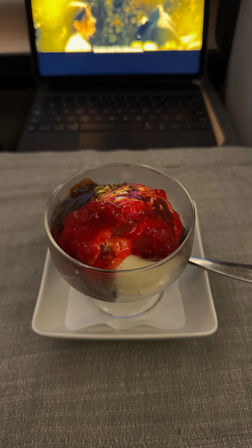 The ice cream sundae, topped with berry sauce, for dessert.