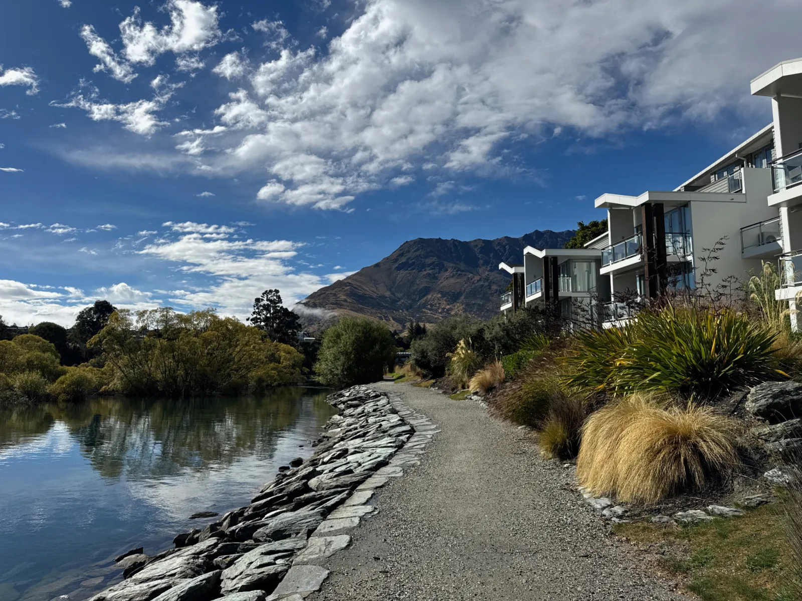 The waterfront walking path outside Hilton Queenstown Resort & Spa, visible on the right.