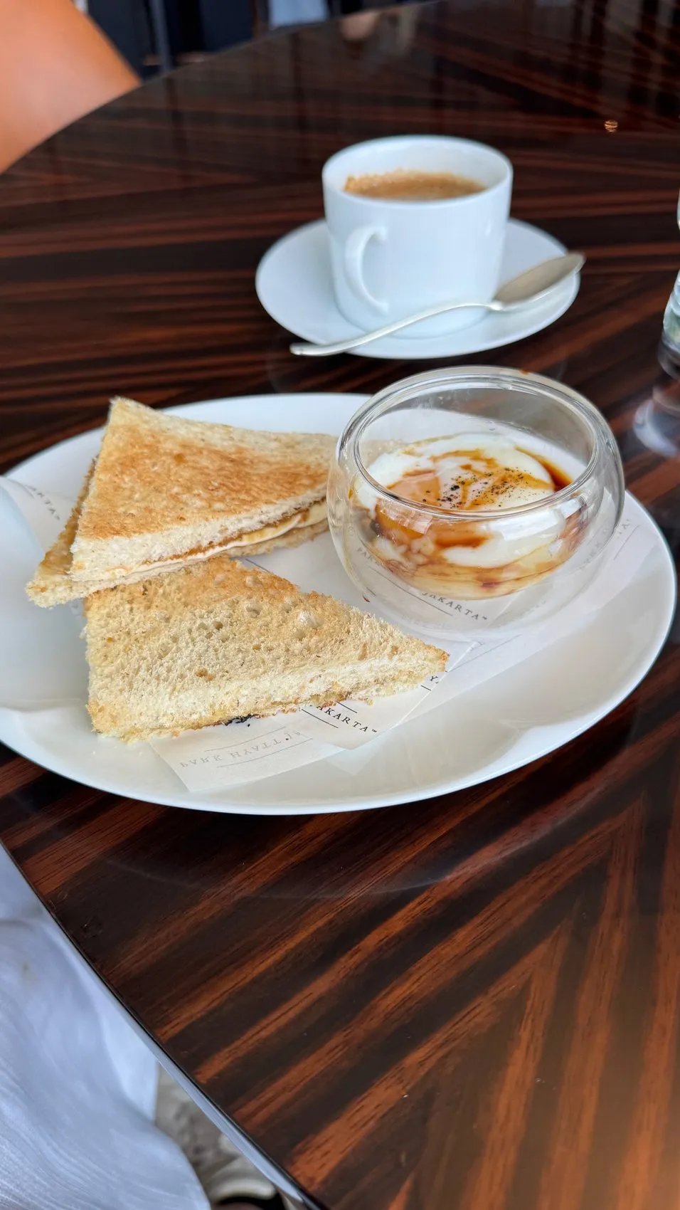 A beautifully presented egg-and-toast breakfast, with coffee on the side.