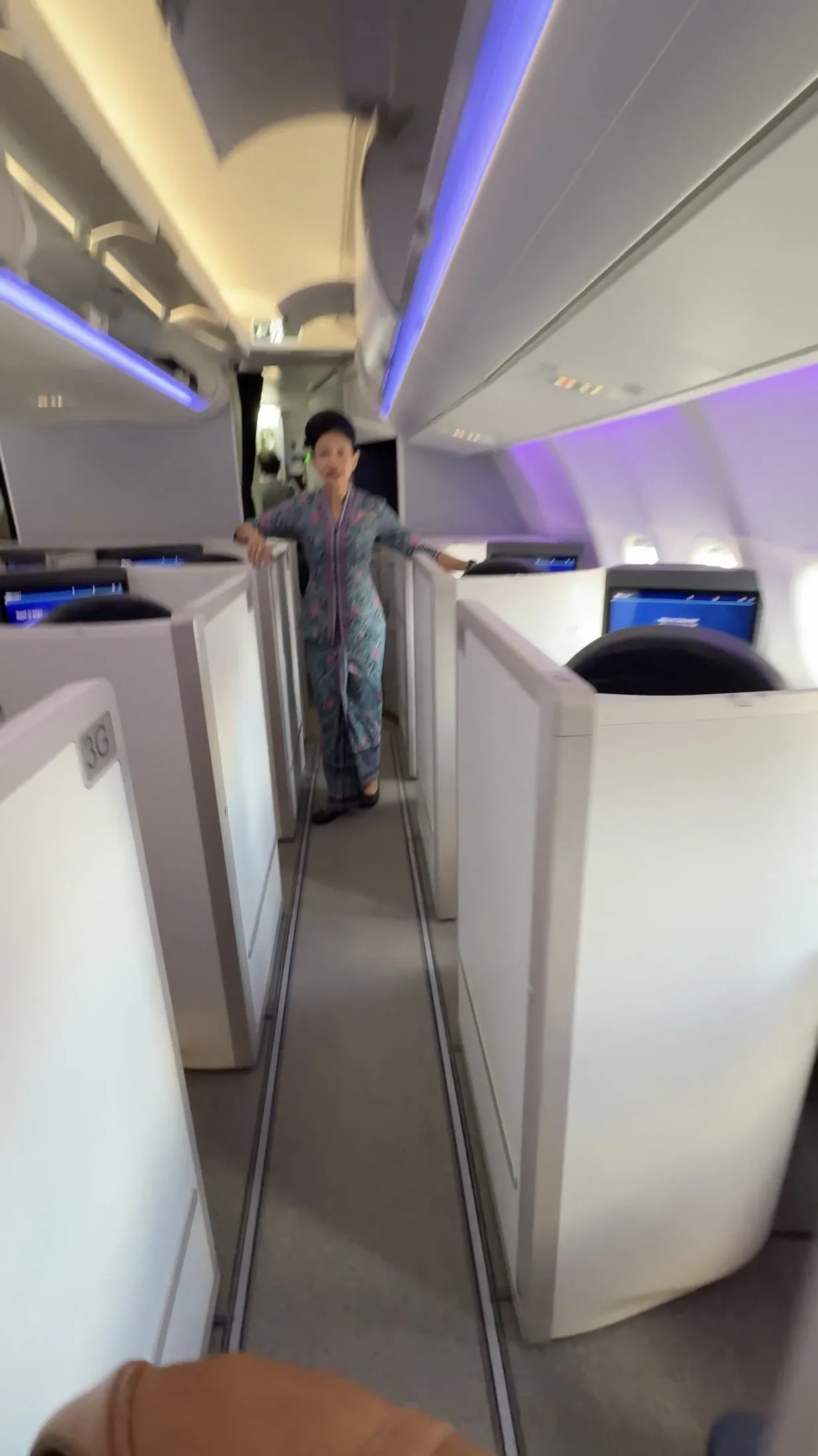 The Business Class aisle and crew during boarding.