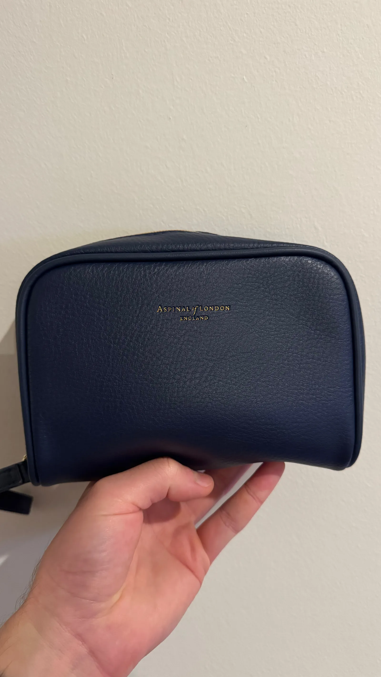 The navy-blue Aspinal of London amenity pouch.