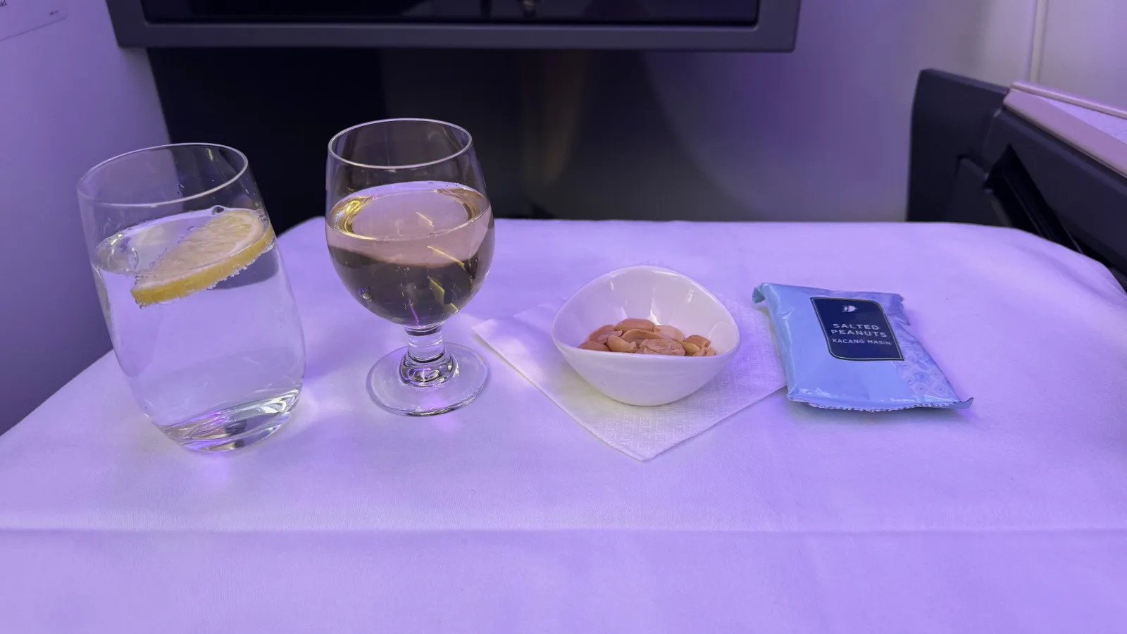 Water, Champagne, warm nuts and a pack of salted peanuts.