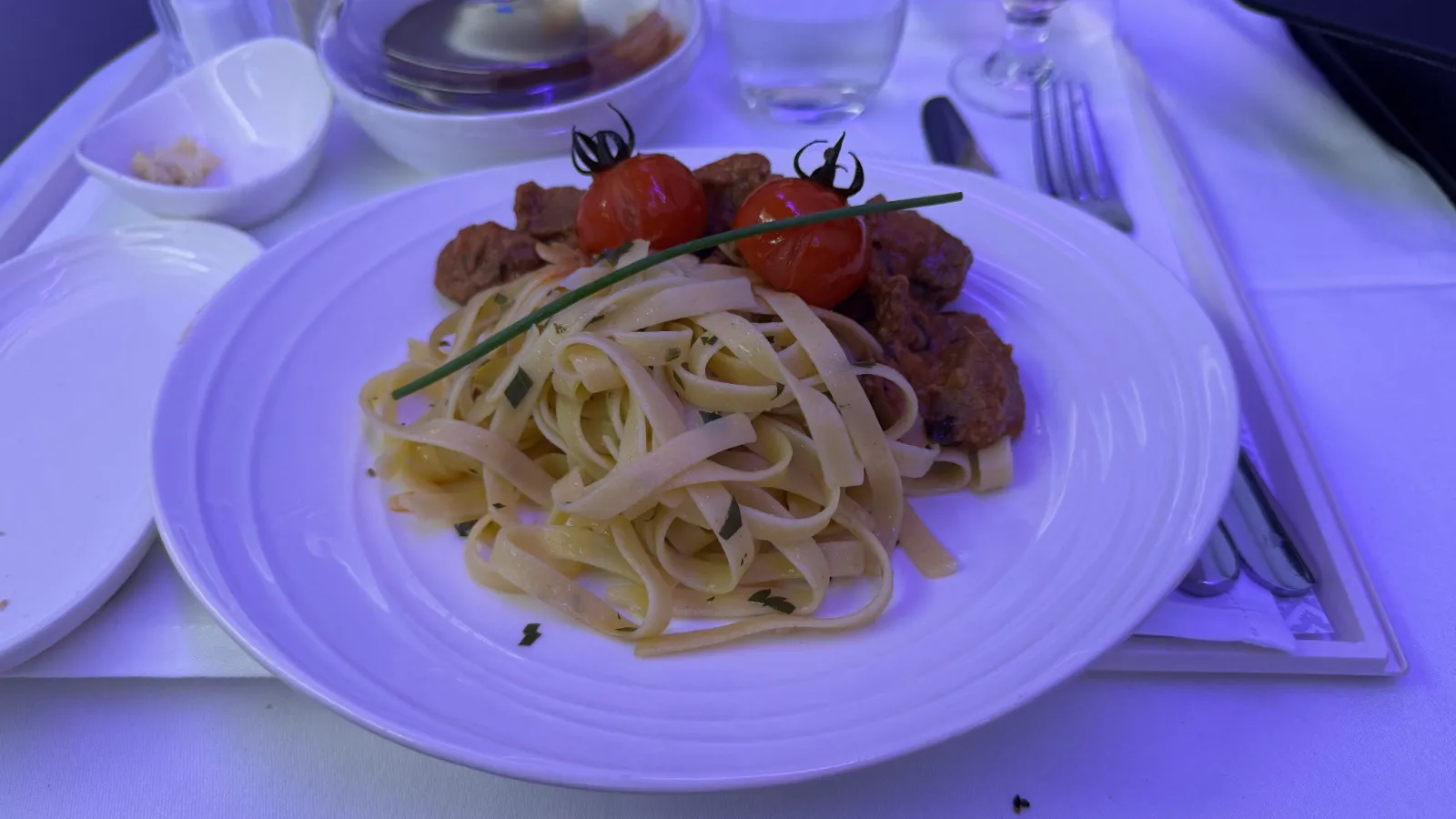 Beef stroganoff with fettuccine and cherry tomatoes.