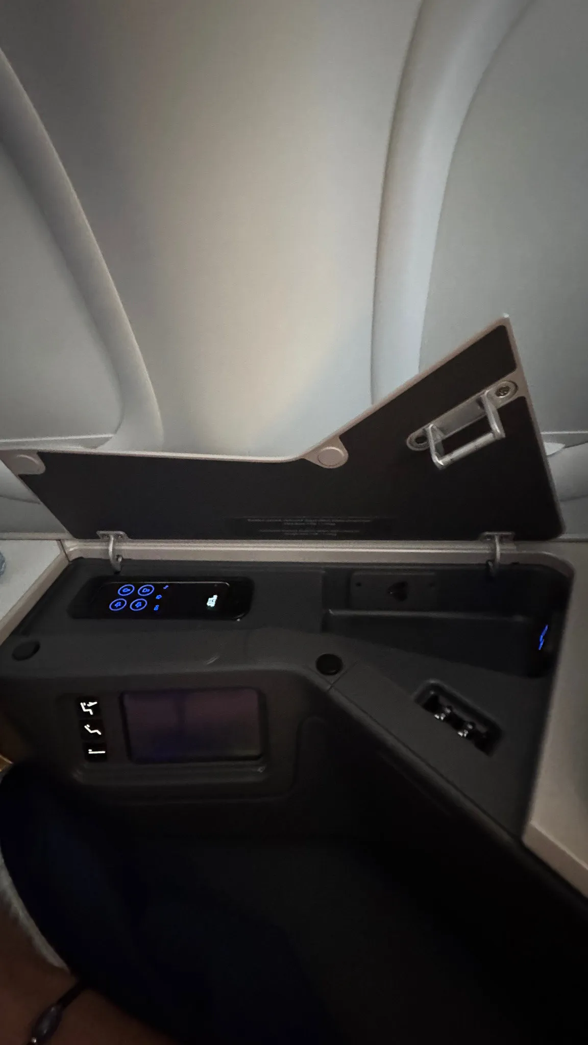 The side compartment with the seat controls, outlets and extra storage.