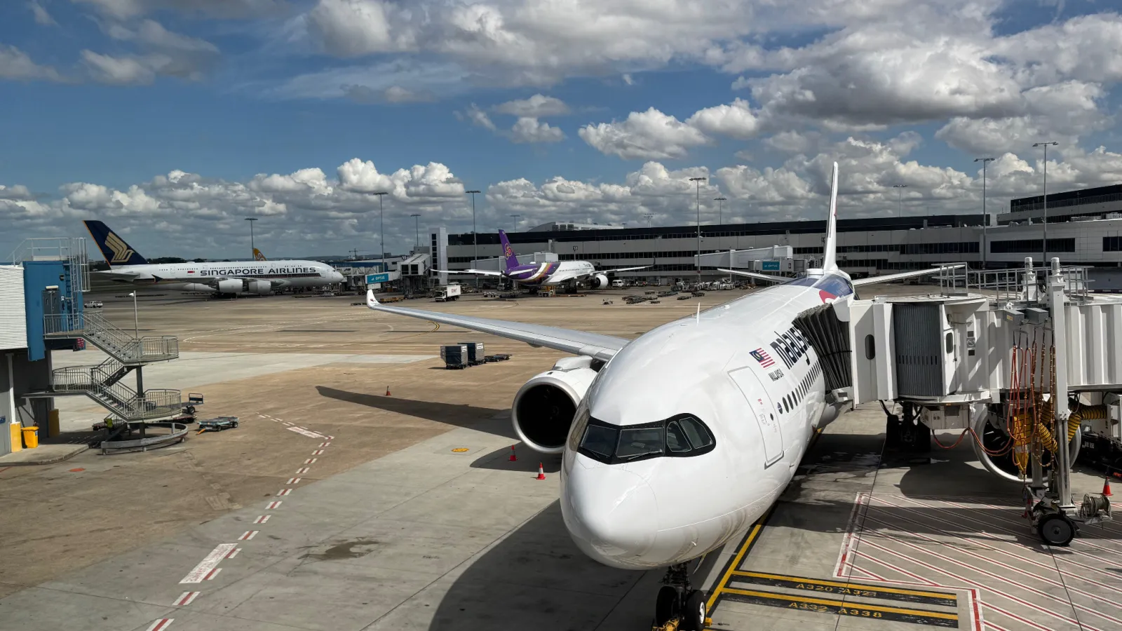 Our brand-new Malaysia Airlines A330-900neo waiting at Sydney Airport with a Singapore Airlines A380 right behind it.