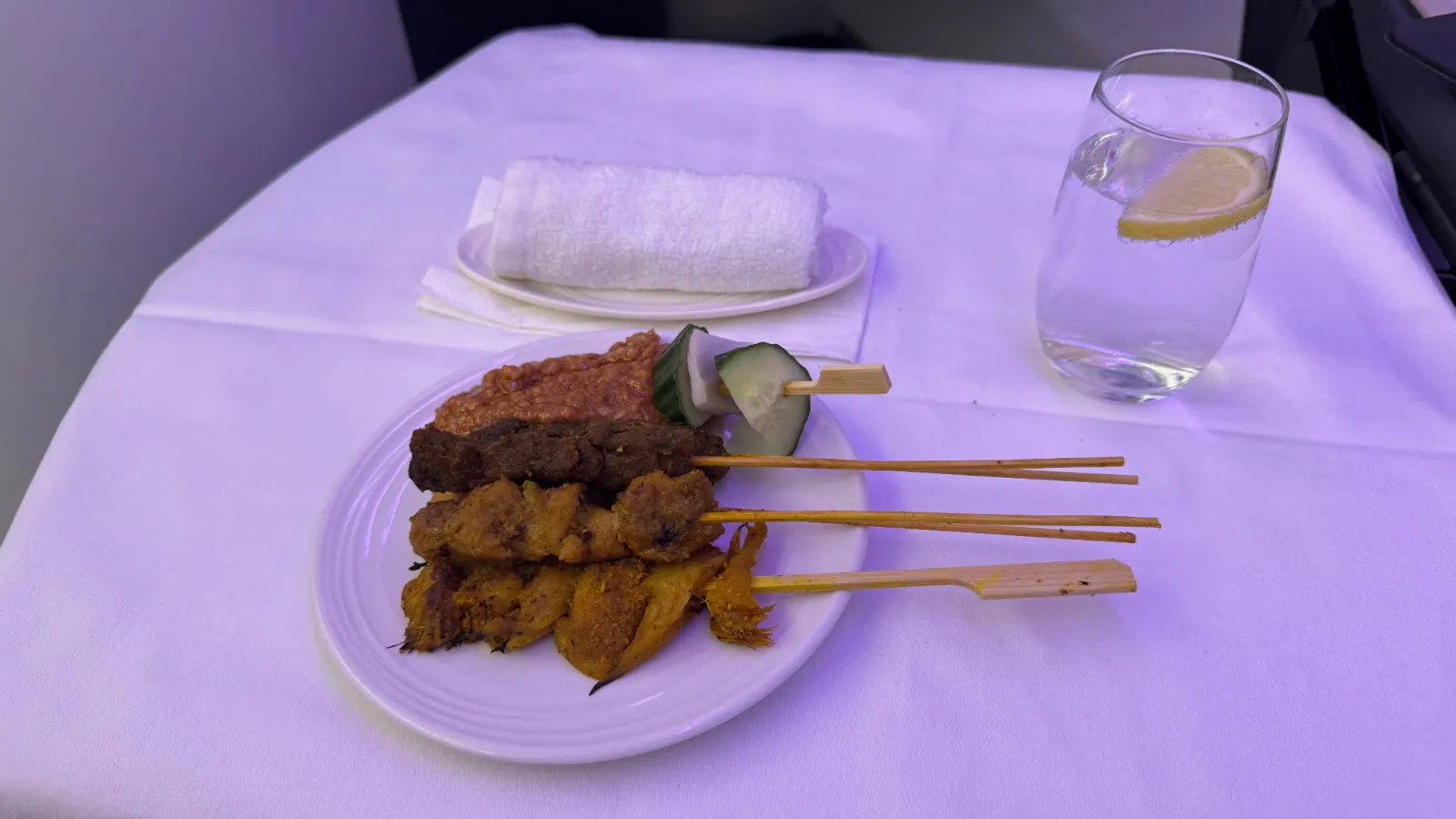 The famous Malaysia Airlines satay with peanut sauce, cucumber and onion.