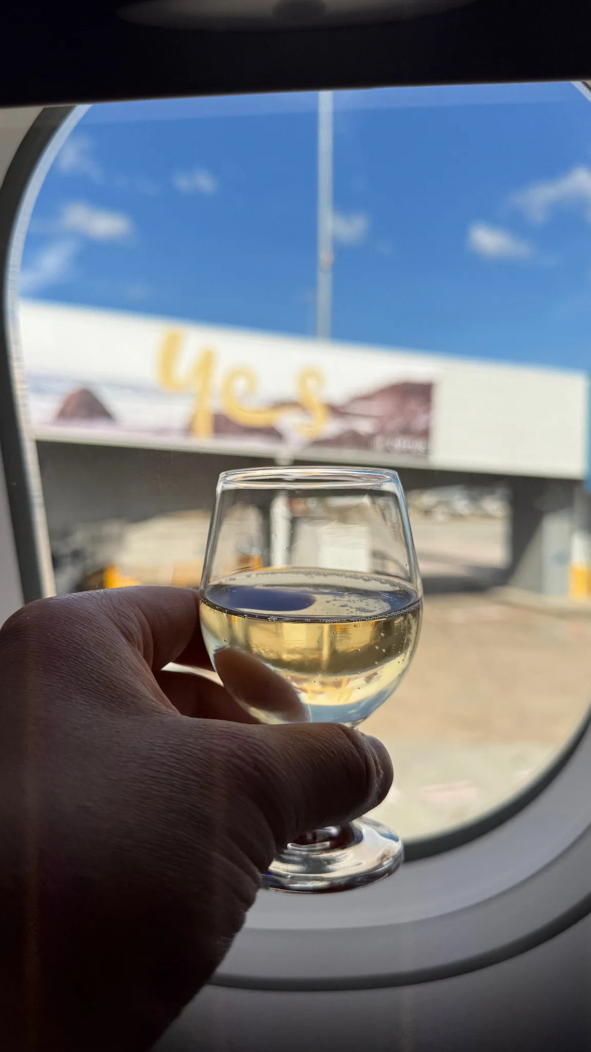 A glass of Champagne by the window before pushback.