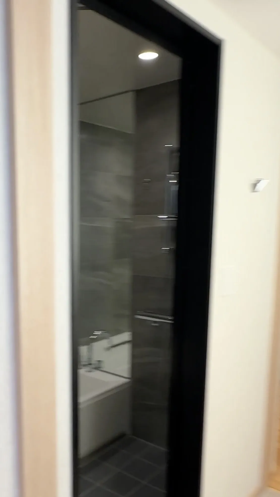 The separate bathing area, with a bathtub and shower.