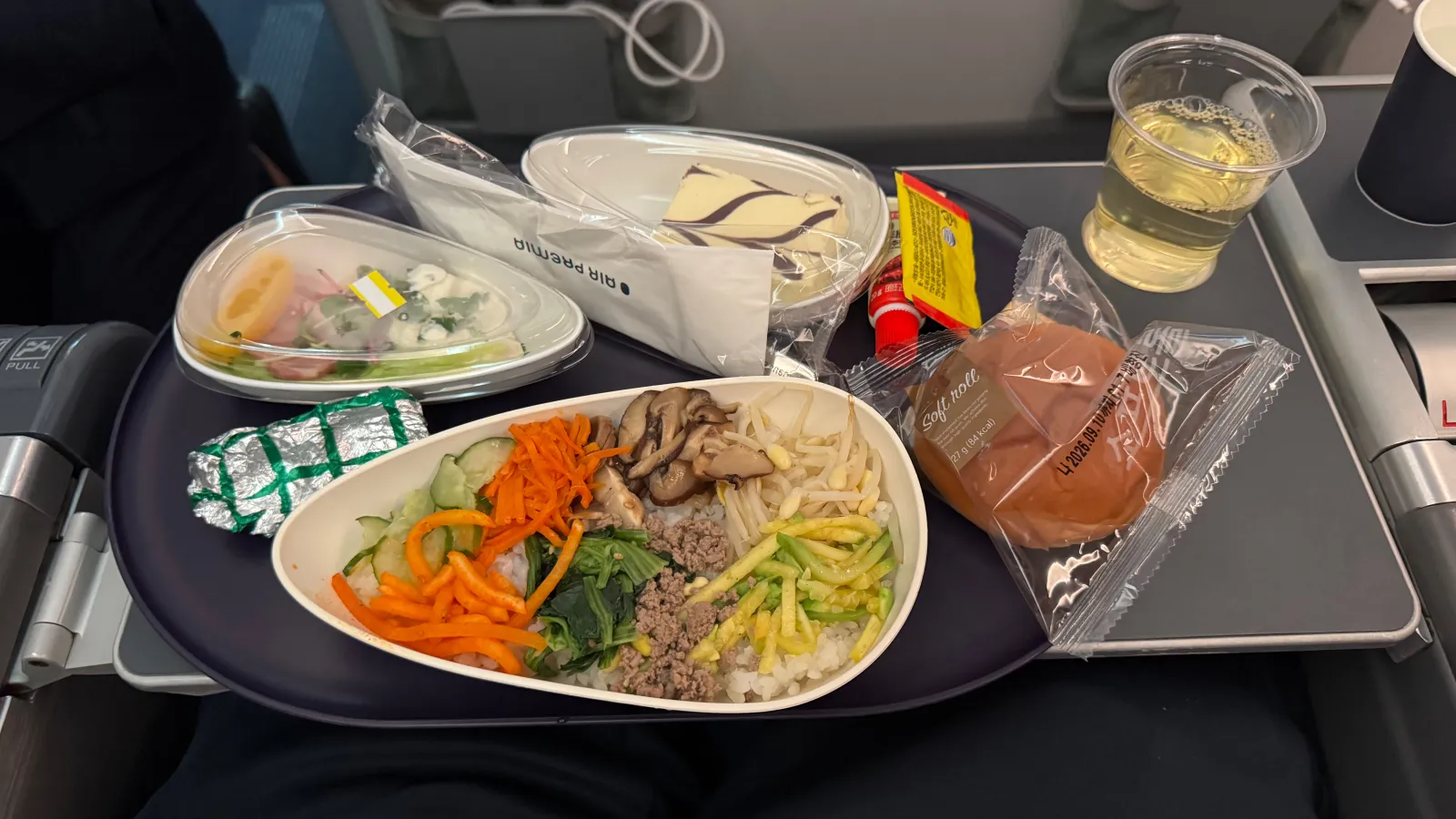 First meal: beef bibimbap, salad, bread, dessert, and drinks.